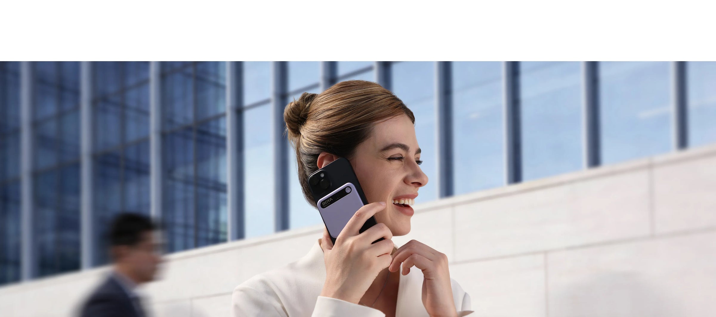Women talking on a phone with Boya Notra attached